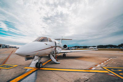 Airplane on runway against sky