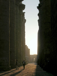 Silhouette of men walking on street