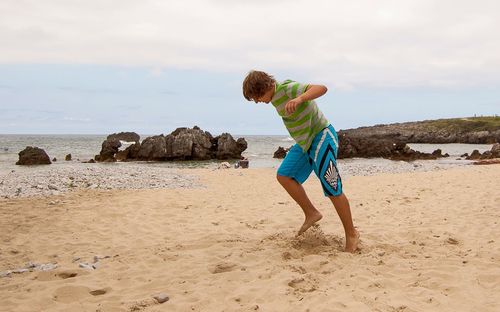 Teenage boy enjoying on the beach