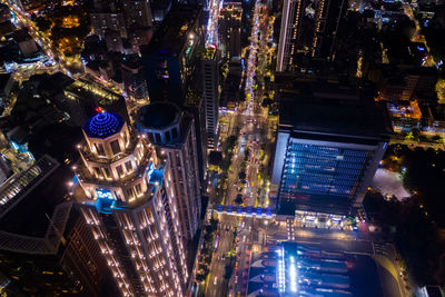 High angle view of illuminated buildings in city at night