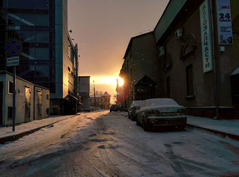 Cars on road in city during winter at night