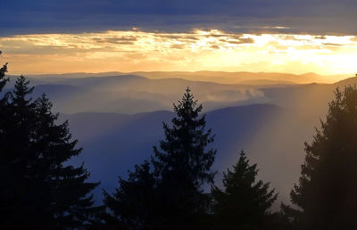 Scenic view of silhouette mountains against sky at sunset