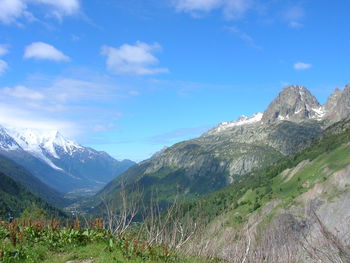 Scenic view of snowcapped mountains against blue sky