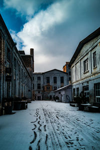 Street amidst buildings in city against sky