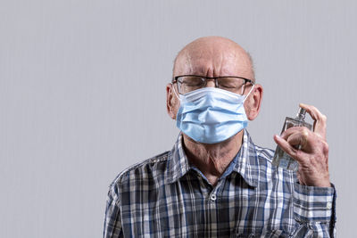 Portrait of man wearing mask against white background