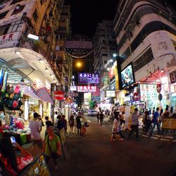 People walking on city street at night