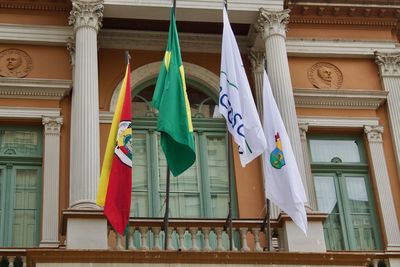 Low angle view of flags hanging on building