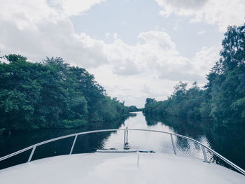 River amidst trees seen from yacht deck