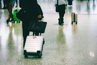 Low section of people walking at airport