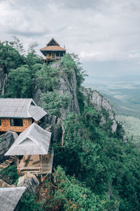 Built structure on building by mountain against sky