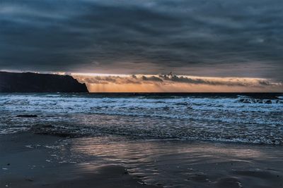 Scenic view of sea against dramatic sky