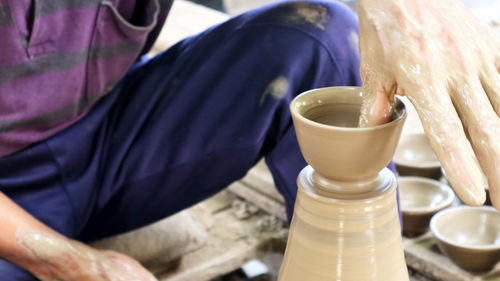 Midsection of potter making clay product