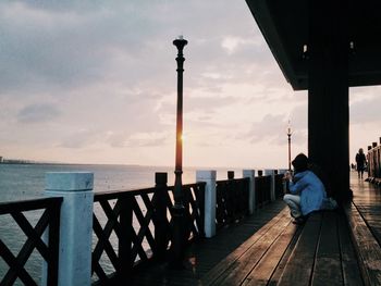 Pier on sea at sunset