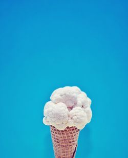 Ice cream cone against blue background