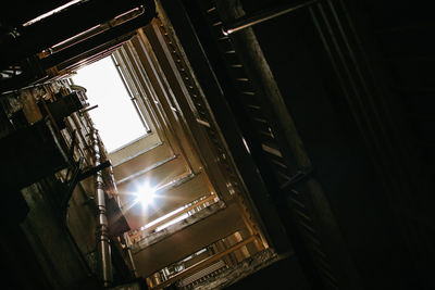 Low angle view of illuminated lamp in building