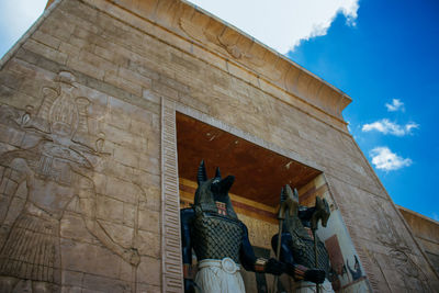 Low angle view of statue against building
