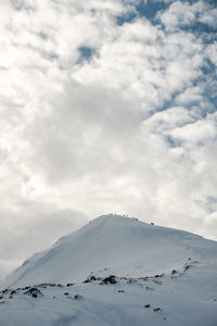 Low angle view of snow on mountain against sky