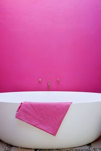 High angle view of pink paper on table against wall
