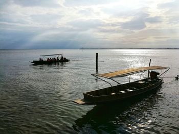 Boat sailing in sea against sky