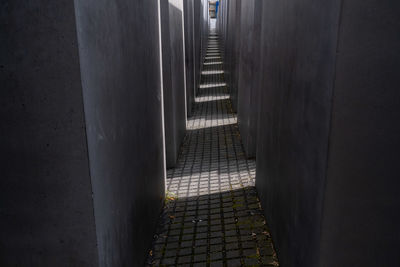 High angle view of footpath by wall in city