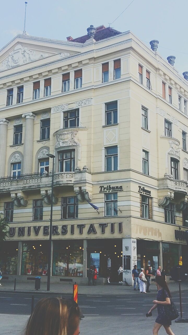 PEOPLE WALKING ON STREET AGAINST BUILDINGS