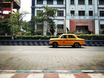 Car on street against buildings