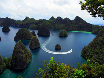 Scenic view of waterfall against sky