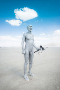 Statue of man standing on desert