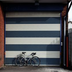 Bicycle leaning against garage door