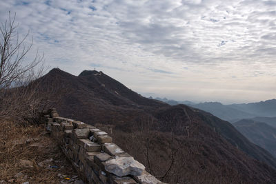Scenic view of mountain against cloudy sky
