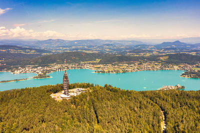 High angle view of woerthersea with pyramidenkogel against sky