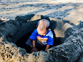 Full length of boy on rock at beach