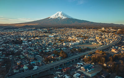 Aerial view of illuminated cityscape against sky