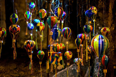 Close-up of decorations hanging in market for sale