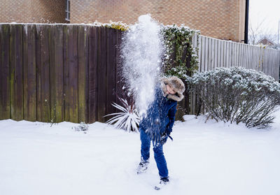 Full length of woman standing in snow