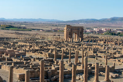 Old ruins in city against sky