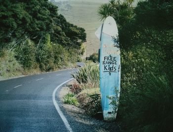 Close-up of road sign by trees