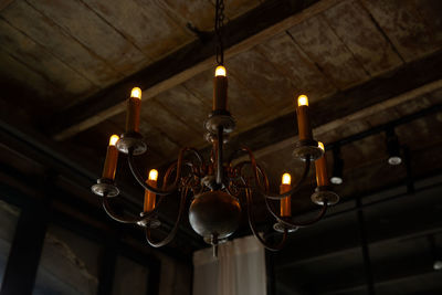 Low angle view of electric lamp hanging in ceiling