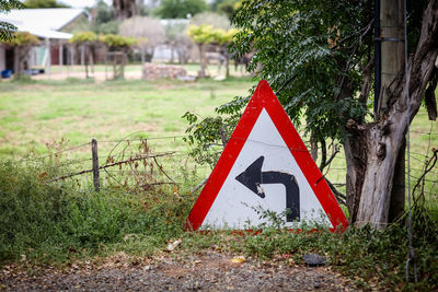 Close-up of road sign on field