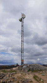Low angle view of communications tower against sky