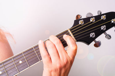 Midsection of man playing guitar