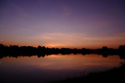 Scenic view of lake against romantic sky at sunset