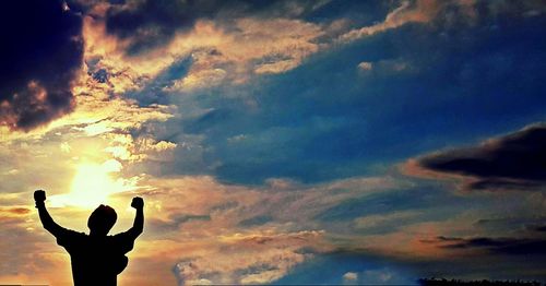 Silhouette man against sky during sunset