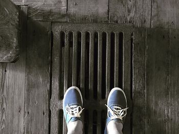 Low section of man wearing shoes