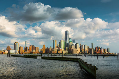 Panoramic view of river and buildings against sky