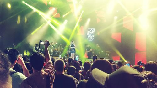 People enjoying music concert at night