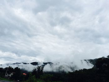 Scenic view of mountains against cloudy sky