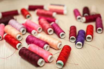 High angle view of colorful thread spools on table