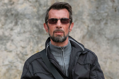 Portrait of man wearing sunglasses standing outdoors