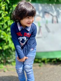 Portrait of cute boy standing outdoors
